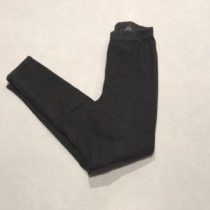 Black jeggings, small tattoo brand